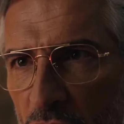 The Director — The silver-haired man who runs the facility