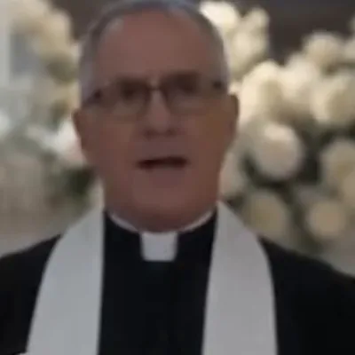 The Officiant — The minister who married two strangers at the altar