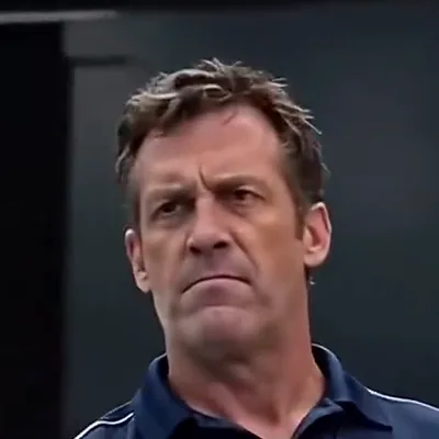 The Coach — The swim-dean in the navy polo