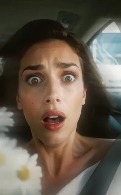 Evelyn's shocked face in the car