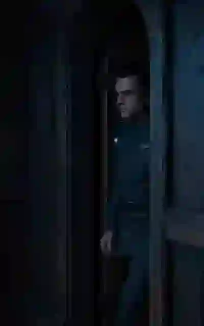 The alpha man standing in the cabin doorway
