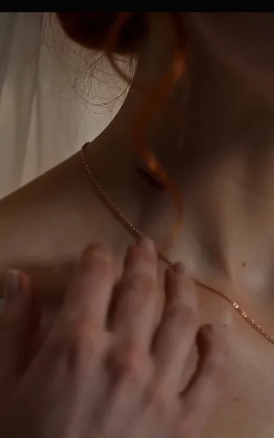 The caught breath at her necklace's clasp