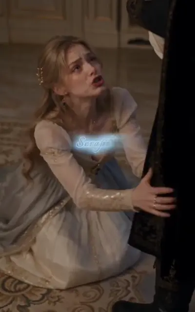 The mother kneels pleading beside the standing dark figure