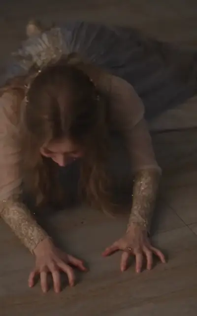 The mother collapses forward on the marble floor