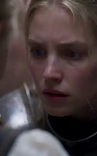 The mother's close, frightened face in the palace hall