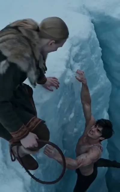 The captive woman leaning over the wall as Kael hangs below