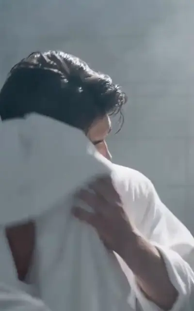 Two boys in towels in a shower room