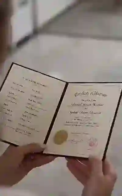 The signed marriage certificate held up