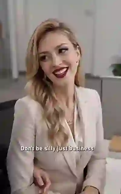 Sophie in the cream suit among the staff