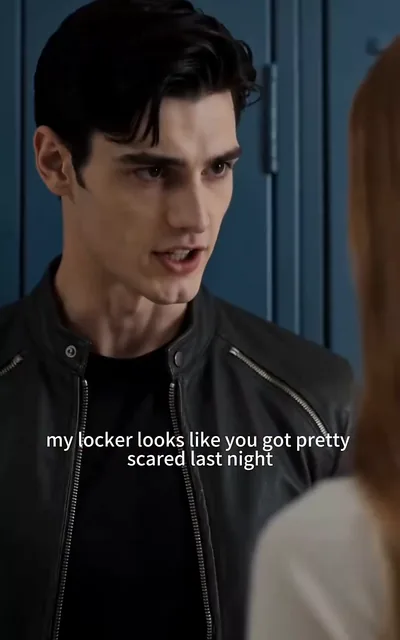 Liam leaning on her locker