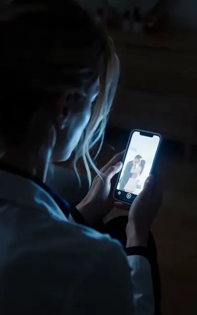 Lynn watching the anonymous video on her phone