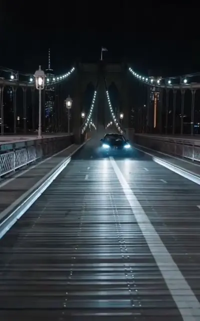 The bridge at night with the car lights arriving