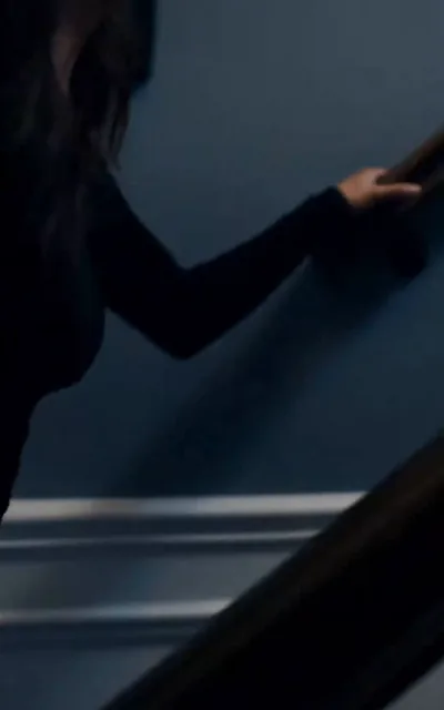 Blackwood watching the confrontation from across the room
