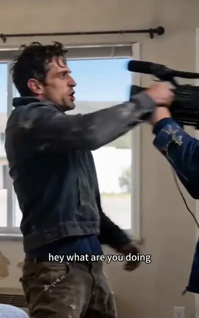 Mike faces a camera being shoved toward him