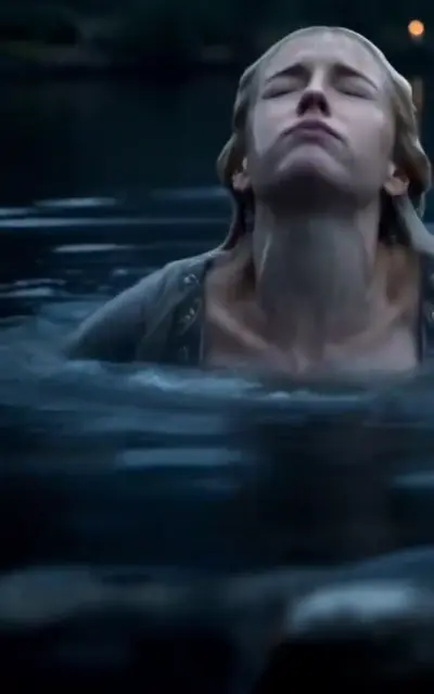 Alara half-submerged in the pond at night