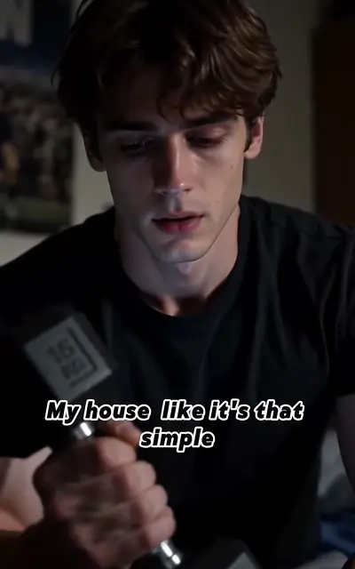 Carter grips the dumbbell in a dark room, head down