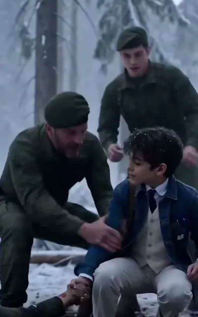 Soldiers help a boy through a snowy wood