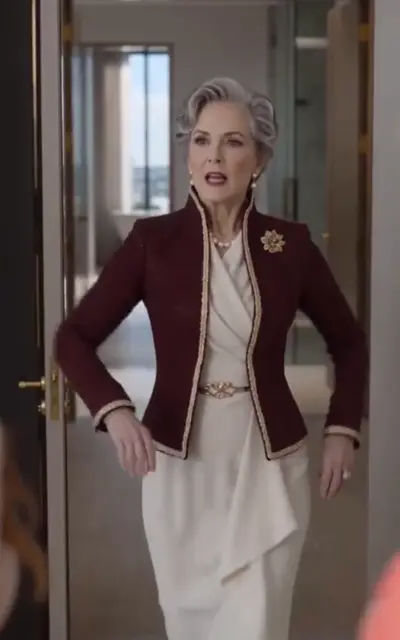 The grey-haired elder stands in the doorway