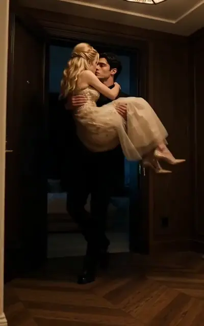 A man carries the woman through a doorway