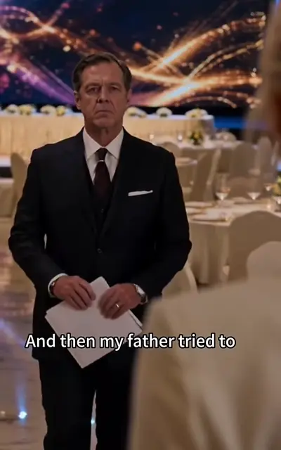 The father holding papers in the ballroom