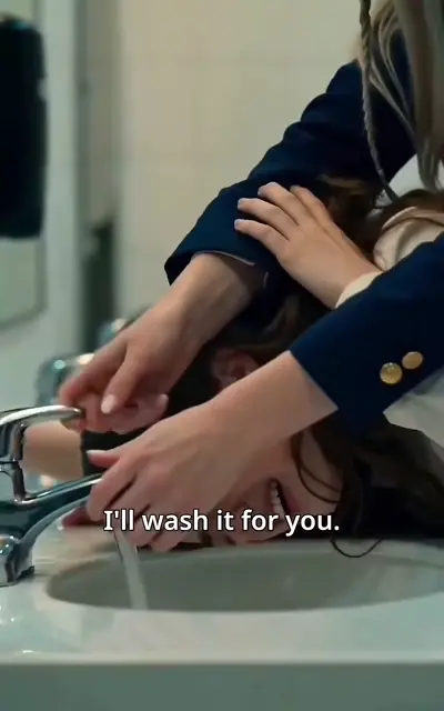 Hands at the school sink washing her off