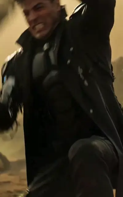 Kalen moves through firelight in black armor