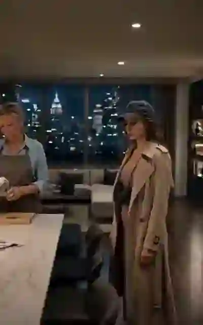 Sabrina in the trench coat and cap by the city window