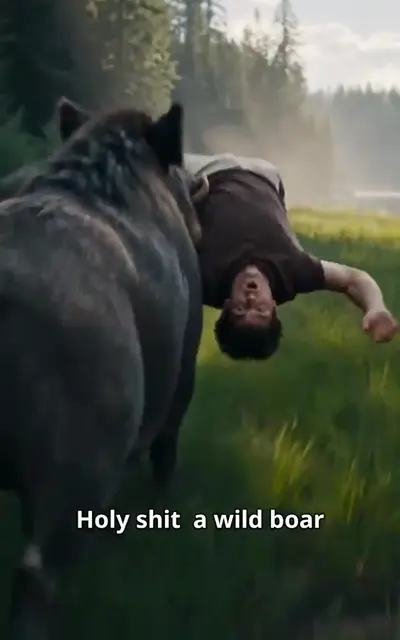 Ethan hangs upside-down over a charging boar in a sunlit meadow