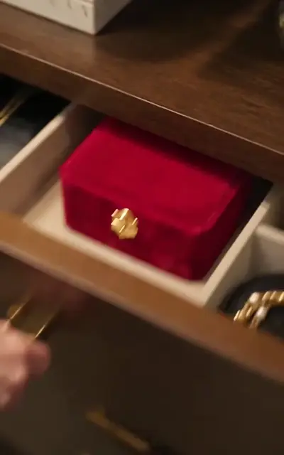 An open drawer revealing a red jewelry box