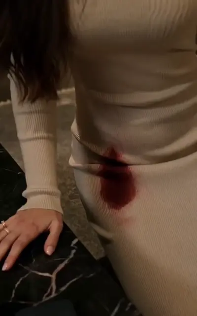 Blood on Olivia's skirt on the couch